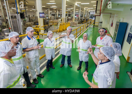 Multinational cosmetics company headquartered in France L`Oreal plant in Rio de Janeiro, Brazil - daily performance production meeting - employees from different departments (quality control, maintenance, manufacturing) analyze how to improve line production efficience. Stock Photo